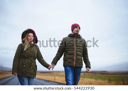 walking man and woman holding hands
