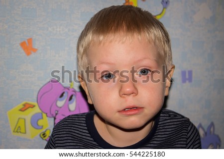 a boy with blond hair and blue eyes