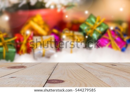 empty wooden board with colorful pink gift box background and fake snow