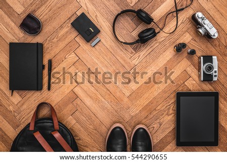 Hipster, artist items on wooden floor. Top view of photography stuff with cameras, backpack, tablet on wooden floor. Copy space. View from above. Flat lay.