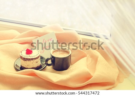 Note I love you with cup of coffee and cake near the window and snow outside. Cozy winter breakfast. Good morning. Happy valentine's day. Be my Valentine Note. Breakfast for a loved one.