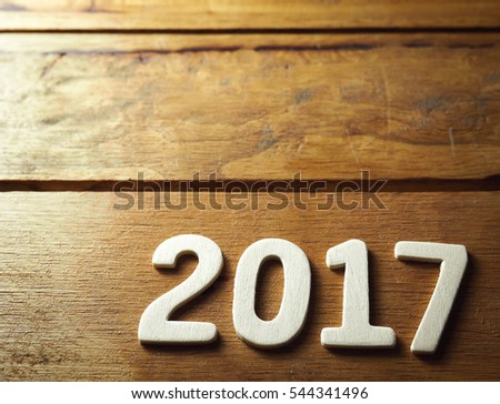 happy new year 2017 alphabet on old wood background