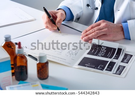 Close up of Doctor's hands signing on a Medical Report at his Office. Health care, Medical and Pharmacy Concept.