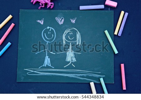 happy couple: colorful drawing in  chalk.Chalkboard background.Top view

