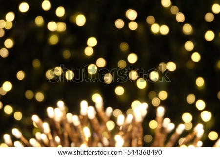 beautiful blurred flower shape light decoration design and bokeh light green christmas tree background, holiday abstract, blur defocused. look like fireworks celebration at night on new year's day.