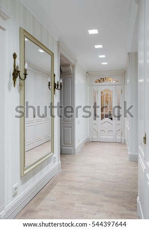 Hall in the flat. Wooden design, white colors. Wooden floor.