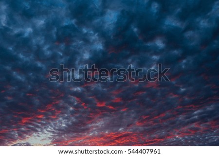 red sunset and clouds on the dark blue sky