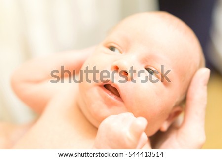 Cute newborn baby in mother's hands. Stock photo