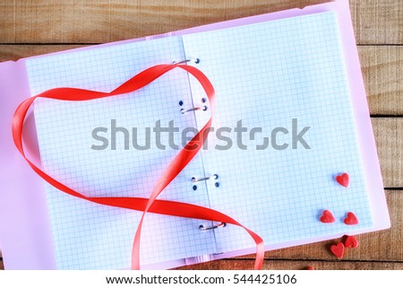notepad and red tape in the form of heart, copyspace