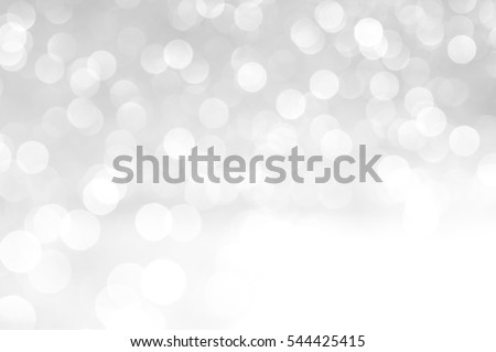 silver Sparkling Lights Festive background with texture. Abstract Christmas twinkled bright bokeh defocused and Falling stars. Winter Card or invitation. Royalty-Free Stock Photo #544425415