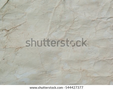 Background of textured paper with spots and folds