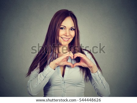 Closeup cheerful woman making heart sign with hands isolated on gray background. Positive human emotion feeling attitude body language
 Royalty-Free Stock Photo #544448626