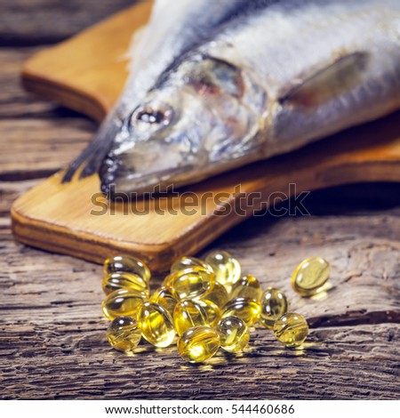 Fish oil capsules on an old wooden table