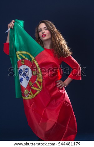 Beautiful brunette woman with Flag of Portugal. Toned image.