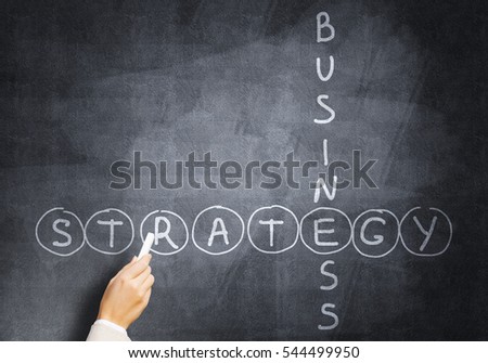 Business concept with crossword drawn with chalk on blackboard