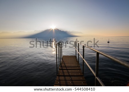 Perspective view of a wooden pier on the pond at sunset, Switzerland