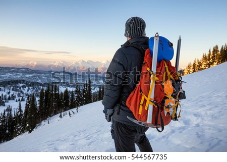 Man enjoying the beautiful mountain view during sunrise. Picture taken in Garibaldi Provincial Park, BC, Canada.