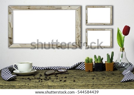 Wooden workplace desktop with coffee cup, plants,flower, Frame on old wooden table.
