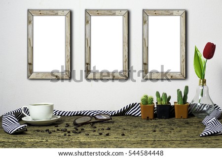 Wooden workplace desktop with coffee cup, plants,flower, Frame on old wooden table.