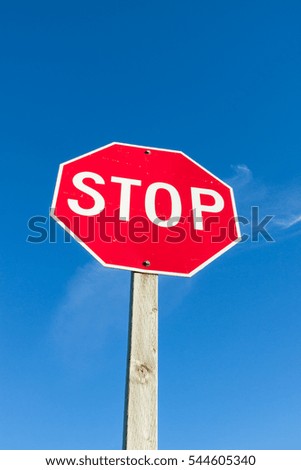 Red Stop Sign Against Blue Sky