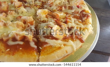 close up of pizza on wooden background