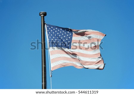 faded USA flag waving in the wind