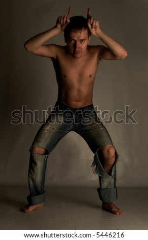 man with horn in torn jeans
