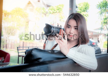 beautiful asia girl with camera in cafe with travel concept