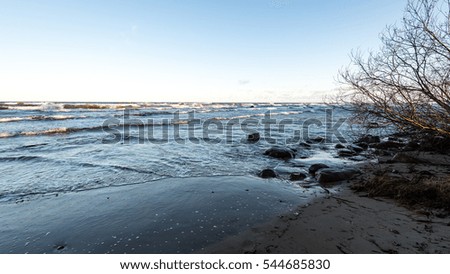 rocky sea beach with wide angle perspective over the sea clouds