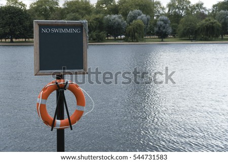 No Swimming sign at lakeside, Hyde park, London
