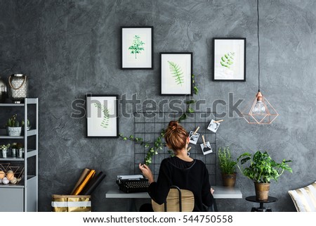 Room area with woman working at the desk