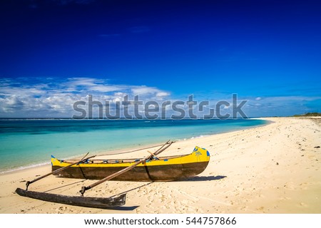 Small traditional pirogue on the shore of Nosy Ve island in Madagascar, Africa Royalty-Free Stock Photo #544757866
