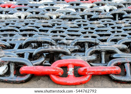 ship anchor chains black and red a lot of in ship yard on the floor background selective focus