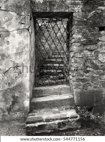 Black and white gate in the wall with textures