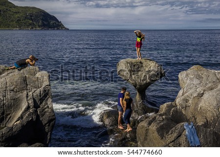 Process of photo shooting on stones near by sea in Norway