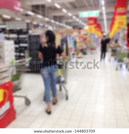 Blurred customer shopping at the supermarket