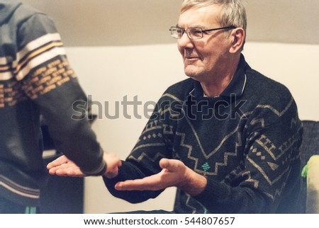 Grandfather and his grandson playing some games with their hands
