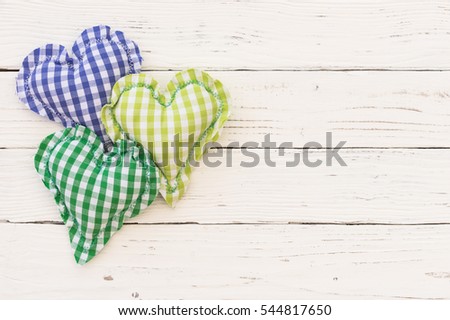 Rustic hearts on white wood background with copy space.