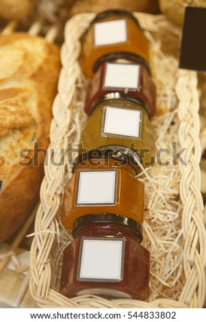 Jar with sweet honey jam on sale in cafe.Empty white frame for text.Close up,focus on jars.Buy this delicious dessert for sandwiches and coffee break