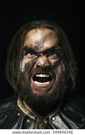 Photo of screaming viking warrior on black background.