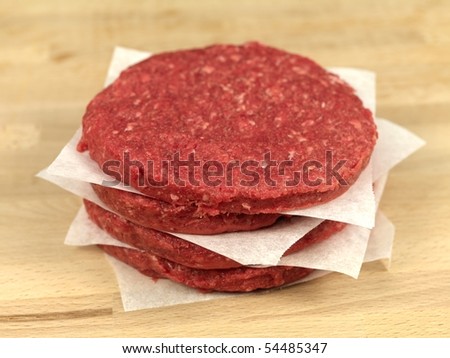 raw hamburger patties on a kitchen bench