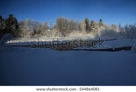Snowy winter in the taiga river. Russia Siberia.