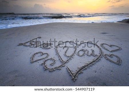 The word love in the sea on the beach in Valentine Day. Closeup.