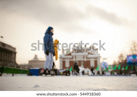 abstract background blur ice rink. people children are skating, relaxing and having fun on winter vacation