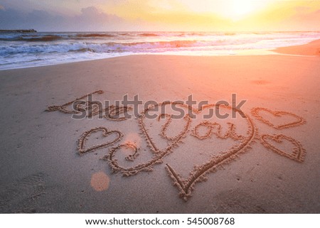 The word love in the sea on the beach in Valentine Day. Closeup.
