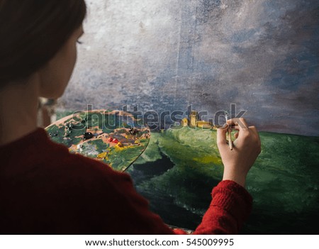 Girl artist paints landscapes oil