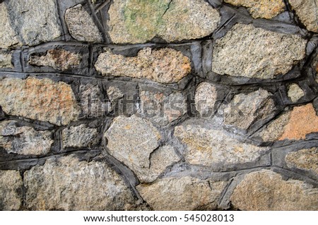 Texture of the granite stone wall as a background