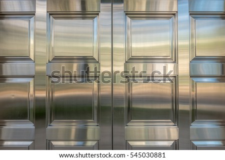 Closeup view of Chrome Steel Exterior Doors with detail and reflections.