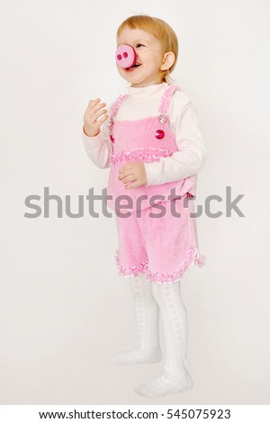 Baby girl in costumes Peppa Pig in carnival of New Year