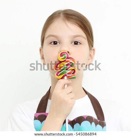 little girl holding lollipop